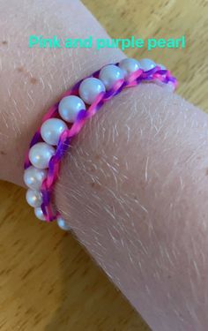 a pink and purple beaded bracelet on someone's arm with the words pink and purple pearl