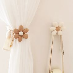 a white curtain with two flower decorations on it