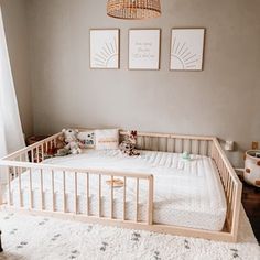 a baby crib in the corner of a room with two pictures on the wall