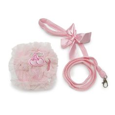 a pink dog leash and hat with a bow