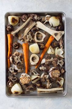 carrots, mushrooms and other edible items in a pan