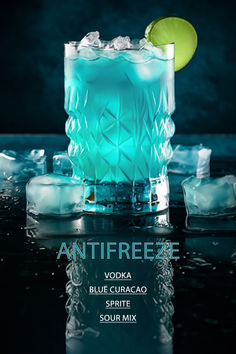 an advertisement for vodka with ice cubes and a lime on the rim in front of it