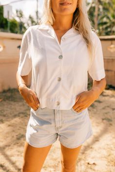 The ultimate white shirt. Besides the fact that this shirt is made from upcycled material, it is the one item you MUST own in your closet. The most versatile item, a core staple piece. Made for the modern women, this is the new white button down shirt, no basic here. Pay close attention to the repurposed shell buttons, that add that extra touch. Wear buttoned up with your favorite pair of denim or try unbuttoning it over a tank or dress for a layered look. Our Camp Shirt fits loosely in the body Shirt Photography, T-shirt Photography, Camp Shirts, White Button Down Shirt, Camping Outfits, Camp Shirt, White Button Down, White Solid, Modern Women