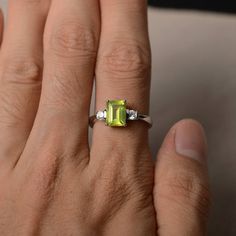 This is a gorgeous handmade creation. Its beauty is its simplicity & Elegance. The 6*8 mm emerald shape faceted natural peridot is crafted in solid sterling silver and with rhodium plated. All item is sent in a beautiful gift box If you have any idea of design your ring,pls contact me directly. You can realize more lovely stuff clicking the link https://www.etsy.com/shop/knightjewelry?refshopsection_shophome_leftnav Please leave the correct address and you phone number for delivering success Emerald Cut Green Gemstones With Accent Stones, Lime Green Gemstone Birthstone Ring As Gift, Lime Green Gemstone Birthstone Ring For Gift, Lime Green Birthstone Ring As A Gift, Green Octagon Diamond Ring, Emerald Cut Peridot Ring For May Birthstone, Green Emerald Cut Crystal Birthstone Ring, Emerald Cut Green Crystal Birthstone Ring, Emerald Cut Peridot Gemstone Jewelry