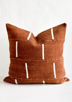 A mudcloth throw pillow in rust with white vertical line motif. Mudcloth Decor, Kuba Cloth Pillow, African Interior Design, Block Printed Pillows, Mudcloth Pillow, African Textiles, Modern Throw Pillows, Pillows And Throws, Perfect Pillow