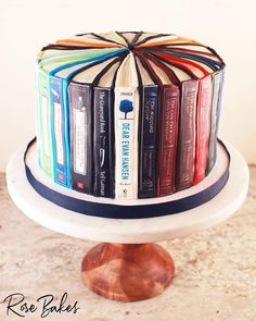 a cake decorated with books on top of a table