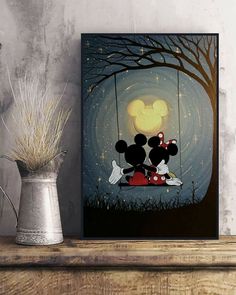 mickey and minnie mouse sitting on a swing at night with the moon in the background