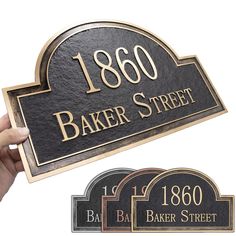 two black and gold plaques with the words 1800 baker street