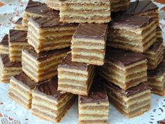 a stack of cut up cake sitting on top of a white doily