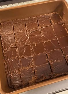 a pan filled with brownies sitting on top of a stove