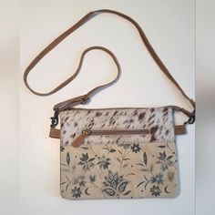 Myra S-1492 "Sanvitalia Crossbody Bag Canvas Floral Print Crossbody With Cowhide Leather On One Side. Black On The Other Side. Zippered Pockets On The Exterior Of Both Side And A Divided Center To Give You Two Sections Inside. Measures Approx: 10"X8". Looks Brand New Inside. Cream Pouch Bag With Leather Handles, Cream Crossbody Shoulder Bag For Travel, Cream Shoulder Bag With Detachable Strap For Daily Use, Beige Leather Handle Clutch Bag, Beige Leather Clutch With Leather Handles, Beige Clutch Shoulder Bag For Daily Use, Everyday Cream Pouch Shoulder Bag, Cream Pouch Satchel With Detachable Strap, Beige Pouch With Adjustable Strap For Everyday Use