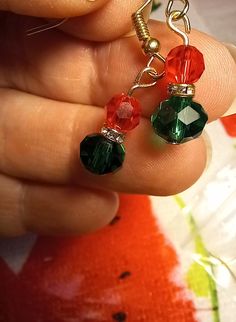 Red and green crystal earrings perfect for the holidays! Gold tone ear wire pierced. 1/2 in drop round shape Red And Green Jewelry, Green Drop Earrings For Holiday, Green Dangle Crystal Earrings For Festive Occasions, Holiday Green Jewelry With Round Beads, Green Dangle Earrings For Holiday, Green Dangle Earrings For Holidays, Red Ear Wire Earrings For Holiday, Red Holiday Earrings With Ear Wire, Holiday Green Drop Earrings