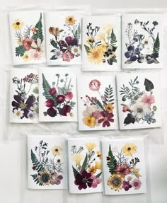 six cards with flowers and leaves on them, all in different colors are arranged together