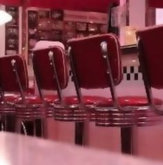 a row of red chairs sitting on top of a counter