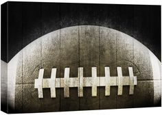 an abstract photograph of a football on a wooden wall with white crosses painted on it