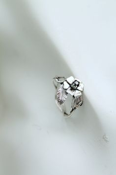 ITEM DESCRIPTION: This ring can be adjustable 6 1/2 - 8 1/2 (US and Canada) N - Q 3/4 (UK and AU) Weight - 2 g. I made this floral ring of sterling silver and garnet. It looks like a blooming wild rose with interwoven branches, leaves, and buds. It is a delicate spring flower that will never fade. Silver rose ring will be a great addition to your jewelry collection or the present for someone whom you love. I can make this ring with various stones - just write to me to discuss the details. I'm al Nature-inspired Adjustable Flower Ring For Anniversary, Adjustable Rose Design Jewelry Ring, Nature-inspired Flower Promise Ring, Adjustable Sterling Silver Flower Ring With Rose Design, Adjustable Sterling Silver Rose Design Ring, Adjustable Flower-shaped Ring With Rose Design, Adjustable Rose Design Flower Ring, Ursula Jewelry, Rose Flower Ring