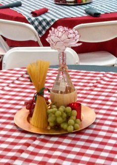 a table with red and white checkered tables cloths, wine bottle shaped like a cone