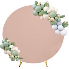 a round table with balloons and greenery on the top, in front of a pink background