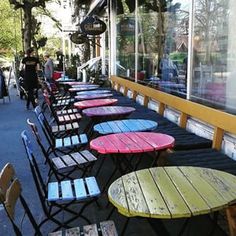 tables and chairs lined up in front of a store