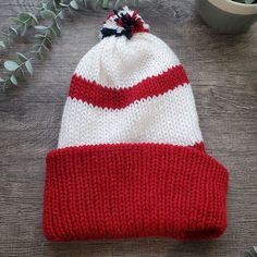 Red and white striped knit hat with pom pom *Made with soft yarn *Double layered for warmth *Sized for adults Handmade Red Yarn Hat, Red Knitted Yarn Beanie, Red Knitted Cotton Hat, Red One-size Yarn Beanie, Winter Hats For Men, Red Hand-knitted Beanie Cap, Hat For Man, Pom Pom Hat, Skull Cap Beanie