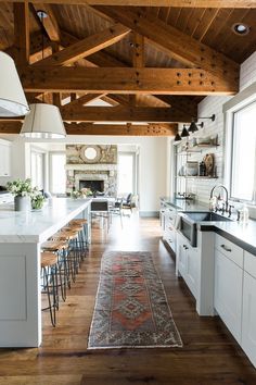 an open kitchen and dining room with wood beams on the ceiling is featured in this instagram