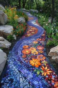 a colorful pathway with flowers painted on the side and rocks in the backround