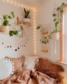 a bedroom with plants and lights on the wall