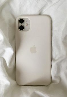 an iphone case sitting on top of a white sheet