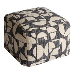 a black and white square ottoman cover with circles on it, sitting in front of a white background