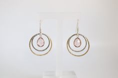 The Double Silver and Gold Pink Dangling Earrings present a unique dual-tone design, combining the cool sheen of silver with the warm luster of gold, each adorned with a delicate pink gemstone that dangles gracefully. This elegant mix of metals and the soft hue of the pink gemstones offer a versatile and feminine accessory, perfect for adding a touch of sophistication to any ensemble. Pink Fusion Style Dangle Jewelry, Pink Fusion Dangle Jewelry, Fusion Style Pink Dangle Jewelry, Modern Pink Jewelry For Anniversary, Pink Sterling Silver Hoop Earrings For Anniversary, Modern Pink Teardrop Jewelry, Nickel-free Mixed Metal Earrings As A Gift, Pink Fusion Dangle Earrings, Modern Pink Dangle Earrings