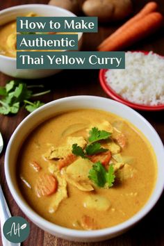 a bowl filled with curry next to rice and carrots on top of a wooden table