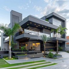 a modern house with palm trees in the front yard and stairs leading up to it