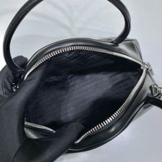 SHOP MORE LUXURY PRODUCTS HERE Description Prada Triangle Bag Black For Women, Women’s Bags 9.8in/25cm 1BB082_2BYA_F0002_V_NEO This soft bag reinvents in an innovative way the classic and sophisticated shape of the top-handle bag, transforming it into a versatile, sporty design. The accessory with double handle and detachable logo-print woven tape shoulder strap can be worn in different ways and is decorated with a modern interpretation of the lettering logo appearing as an embossed detail Designer Crossbody Bag With Zipper Closure, Designer Crossbody Bag With Zipper Pocket, Designer Satchel With Zipper Closure, Classic Black Shoulder Bag With Zipper Pocket, Black Business Bags With Zipper Pocket, Designer Bags With Zipper For Daily Use, Black Top Handle Bag With Zipper Pocket, Modern Black Satchel With Zipper Pocket, Black Handheld Satchel With Zipper Closure