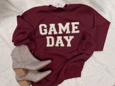 Looking for the perfect Game Day shirt to rep your team? Our beautiful Game Day Sweatshirt is the one for you! This trendy top is a favorite to wear to games, visiting school, running errands or to cozy up in at home. This will absolutely make your friends and team fans ask where you got it from! SIZING:• All sweatshirts are unisex, classic fit. • Sweatshirts are pre-shrunk but may shrink slightly after washing Retail fitSideseamedRibbed cuffs 100% CottonSelect colors 50/50 Cotton & Polyester CA Game Day School Spirit Tops For Fall, School Spirit Tops For Game Day In Fall, Fall Game Day Tops With School Spirit, Fall Game Day School Spirit Tops, Team Spirit T-shirt For Game Day In Winter, Varsity T-shirt For Game Day In Winter, Winter Game Day Varsity T-shirt, School Spirit T-shirt For Game Day In Fall, Winter Game Day T-shirt With School Spirit Style