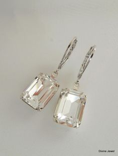 "These romantic earrings have Swarovski emerald cut crystal rhinestones. Lever back ear wires are rhodium finish. Earrings are approximately 1 1/2\" long. Crystal measures 1/2\" by just over 3/8\" at its widest point. Rhinestones have prong set settings. Elegant, classic for any occasion! Please take a look at the rest of the ARIA COLLECTION! http://www.etsy.com/shop/DivineJewel/search?search_query=aria&search_submit=&search_type=user_shop_ttt_id_5851541&shopname=DivineJewel Original Elegant Crystal Jeweled Earrings For Wedding, Elegant Wedding Crystal Earrings, Wedding Earrings Emerald Cut With Prong Setting, Elegant Emerald Cut Earrings For Wedding, Emerald Cut Earrings With Prong Setting For Wedding, Elegant Emerald Cut Wedding Earrings, Emerald Cut Wedding Earrings, Long Crystal Earrings, Teardrop Bridal Earrings