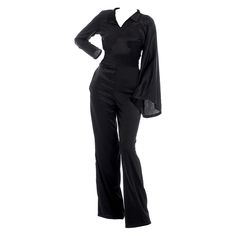 Bring style and elegance to your everyday life with this trendy jumpsuit. Created from two types of black fabric, this design provides all-day comfort. It has a triangular neckline, a classic collar, bell sleeves, a defined waist and wide legs. 57% Rayon 43% Viscose / 62% Rayon 19% Metallized Fiber 16% Polyamide 3% Elastane Hand wash or in a washing machine at no more than 30 degrees. Fall Evening V-neck Pantsuit, Sleek Evening Jumpsuits And Rompers For Fall, Womens Black Jumpsuit, Trendy Jumpsuit, Black Jumpsuit, Jacket Sale, Black Fabric, Independent Designers Fashion, Playsuit Jumpsuit