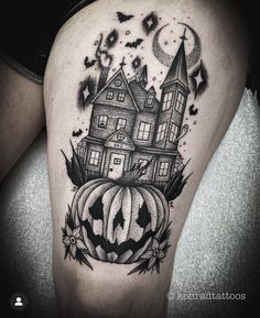 a woman's thigh with a house and pumpkin on it