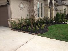 a house with landscaping in front of it