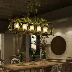 a dining room table and chairs with plants hanging from the chandelier over it