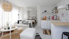 a living room filled with furniture and white walls