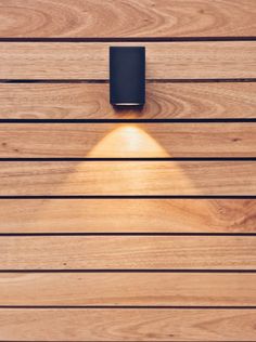 a wooden wall with a light shining on it