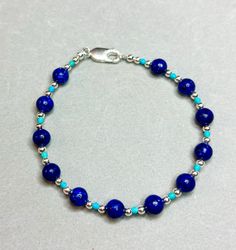 7 inches. Blue Lapis lazuli with turquoise and sterling silver filled beads and clasp. Sterling Silver Jewelry With Polished Blue Beads, Blue Lapis Lazuli Beaded Bracelets With Polished Beads, Nickel-free Blue Round Bead Jewelry, Blue Sterling Silver Bracelet, Blue Sterling Silver Jewelry With Round Beads, Blue Sterling Silver Round Bracelet, Blue Round Sterling Silver Bracelet, Nickel Free Blue Beaded Bracelets With Round Beads, Blue Nickel-free Beaded Bracelets With Round Beads