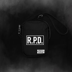 This is a utility crossbody bag that is inspired by the hip pouches found in the Resident Evil 2 and 3 remake games. The R.P.D. logo is directly printed onto the front of the bag, so no worries about peeling or fading! This item is perfect for conventions and cosplay. ----------------------------------------------------------------------------------------- This bag is sturdy, stylish, and ready to go wherever you do. With adjustable straps and two spacious pockets, it's the ultimate accessory fo Functional Black Bag With Logo Print, Functional Logo Print Bag, Functional Bags With Logo Print, Black Crossbody Bag With Logo Patch, Functional Everyday Bags With Logo Print, Functional Crossbody Bag With Logo Patch, Black Shoulder Bag With Logo Print, Black Shoulder Bag With Logo Print For Everyday, Rectangular Shoulder Bag With Logo Patch For Daily Use