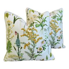 two white pillows with yellow and green flowers on them