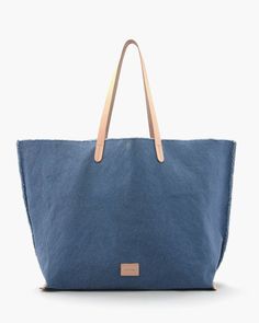 An upscale market tote that functions as well as it looks, the Hana Canvas Boat Bag is a unique and beautiful carryall. Made of heavy-weight canvas in hand-dyed hues that capture the changing light of warm afternoons. Triple wash techniques bring out a relaxed sun-kissed softness to the heavy gauge canvas, while hand-frayed deconstructed edges remind us to let our hair down. The Hana Canvas Tote features sturdy vegetable-tanned leather shoulder straps and trim on the base seams, a nickel snap cl Boat Bag, Weekend Travel Bags, Commute To Work, Hair Down, Market Tote, Sun Kissed, Shoulder Tote, Vegetable Tanned Leather, Tote Backpack