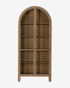 an arched wooden bookcase with glass doors on the front and bottom shelves, in light brown