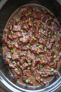 the meat is cooked and ready to be eaten in the crock pot with sesame seeds