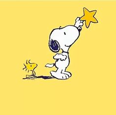 a cartoon character is holding the star above his head as he walks towards a small yellow dog