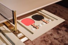 a ping pong racket and paddles are sitting on the side of a table