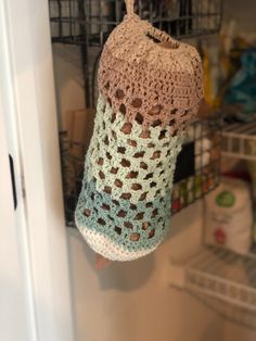 a crocheted bag hanging from a door handle